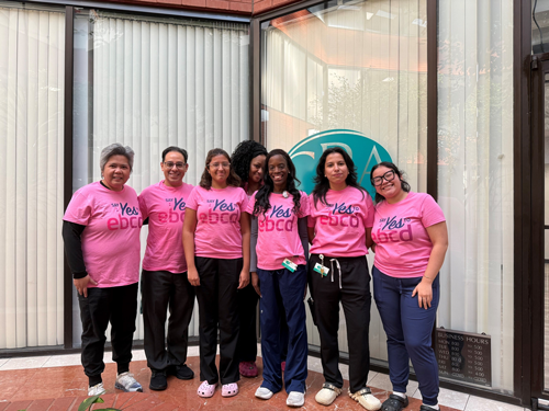 Community members spreading breast cancer awareness at a local event